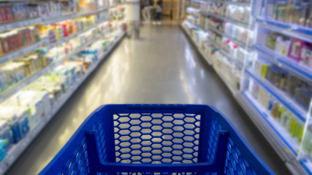 Image of a supermarket aisle from the point of view of the shopping cart